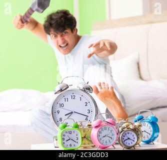 Young man having trouble waking up in early morning Stock Photo