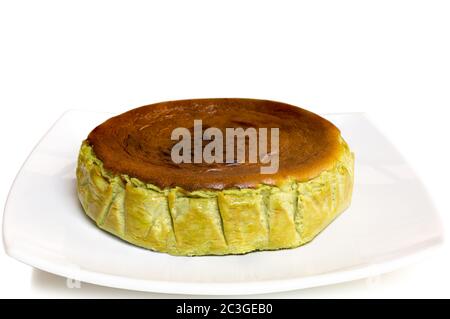 Matcha Green Tea basque burnt cheesecake isolated on white background. Stock Photo