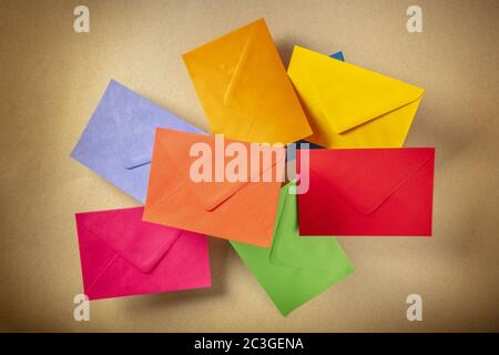 C6 envelopes flying over a brown kraft paper background, of various colors Stock Photo