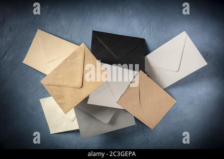 C6 envelopes, brown, gray, and black, flying in the air Stock Photo