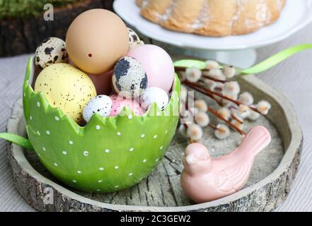 Easter table decorations with painted eggs and ceramic figurines. Festive time Stock Photo