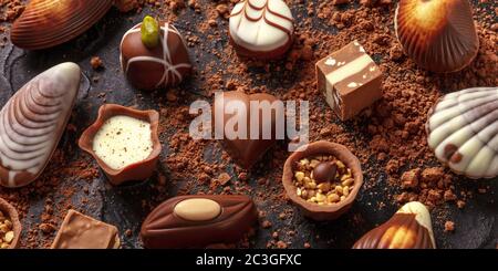 Belgian chocolate assortment panorama, various bonbons on a dark background Stock Photo