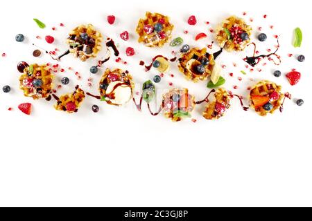 Belgian waffles design template with fresh fruit, chocolate, caramel, and ice cream, shot from the top on a white background, a Stock Photo