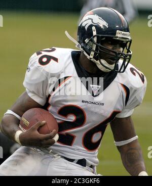 Tennessee Titans Keith Bulluck (53) attempts to tackle Denver Broncos  running back Tatum Bell (26) at Invesco Field at Mile High in Denver,  Colorado, Saturday, August 19, 2006, in NFL preseason action. (