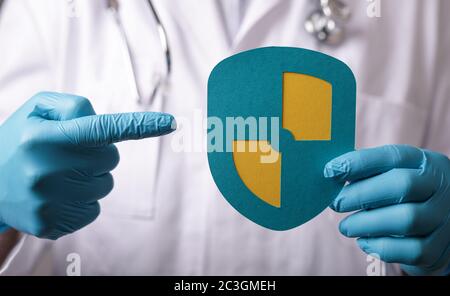 Man holding a protection shield with a checkmark-coronavirus protection Stock Photo