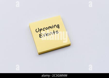 Upcoming events text on sticky paper post note Stock Photo