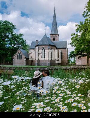 couple men and woman visit a castle in the Netherlands, Castle de Haar Netherlands Utrecht on a bright, young couple men and wom Stock Photo