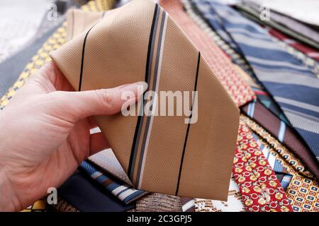 The woman is holding a man's tie in her hand. Man's fashion Stock Photo