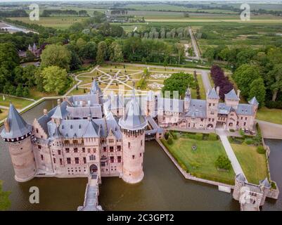 old historical garden at Castle de Haar Netherlands Utrecht on a bright summer day, young couple men and woman mid age walking i Stock Photo