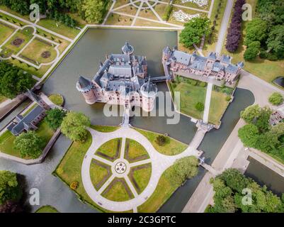old historical garden at Castle de Haar Netherlands Utrecht on a bright summer day, young couple men and woman mid age walking i Stock Photo