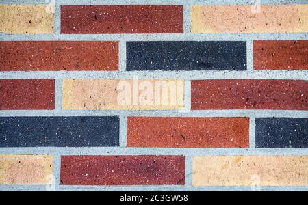 A background of colourful brickwork in red, blue and yellow. Stock Photo