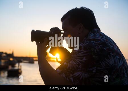 Professional photographers with a DSLR camera taking shot in Dnepropetrovsk on Dnepr river bank, a famous tourist place in  summer in Ukraine south. Stock Photo