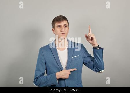 Hand points index finger up, pointing forefinger surprise gift option, idea. Stock Photo