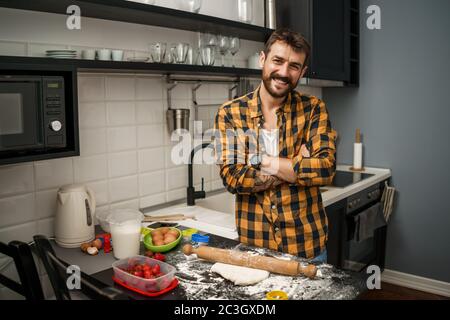 Young man cooking cookies in kitchen Stock Photo - Alamy