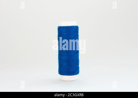 spool of blue thread on white background Stock Photo