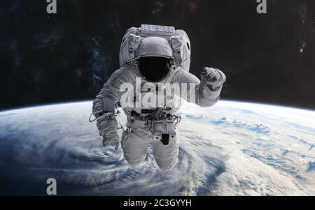Astronaut in orbit of planet Earth. Solar system. 3D render Stock Photo