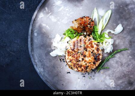 Japanese gourmet salmon fish tartar raw from salmon fillet with king prawns and noodles with spices as top view on a modern desi Stock Photo