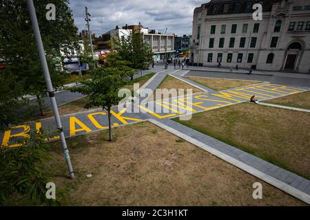 The words 'Black Lives Matter' painted in yellow, covering the length of the walkway from Thomas Street to General Gordon Place in the centre of Woolwich, south London. Stock Photo