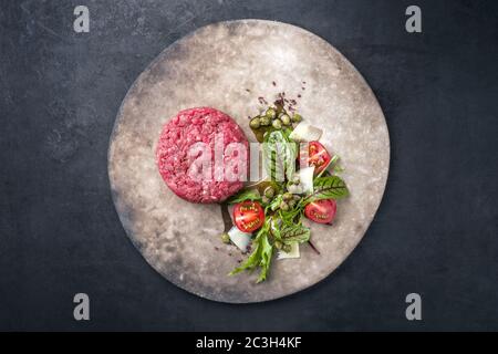Gourmet tartar raw from beef fillet with lettuce Stock Photo