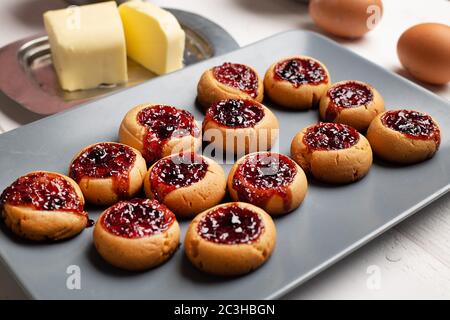 Sweet berry jelly cookies on grey plate on white background. Stock Photo