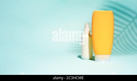 White and orange containers for soap without label on turquoise background, place for text Stock Photo