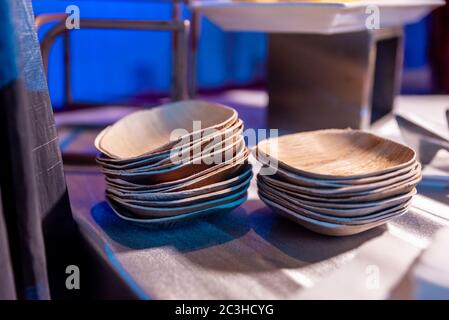 Selective focus shot of ecologically friendly palm leaf plates standing on top of each other Stock Photo