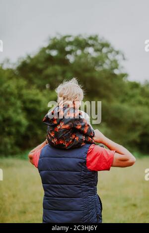 Grandfather carrying grandchild on his shoulders Stock Photo