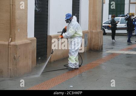 A cleaning worker disinfect the streets with blea as a quarantine is set after the coronavirus (COVID-19) outbreak in the touristic Mallorca  island Stock Photo