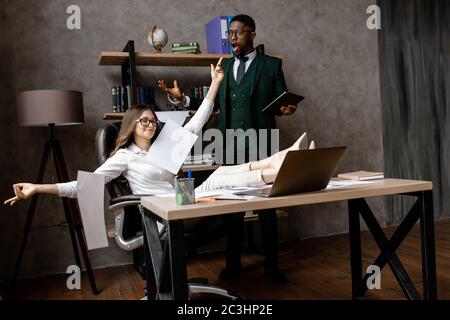 The office worker is scattering paper documents in a desire to take a break from work Stock Photo