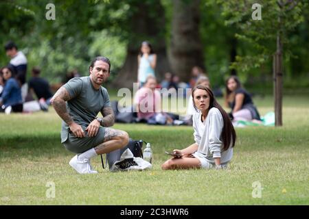 London, UK. 20th June, 2020. Members of the public watch as BLM Protestors march from Parliament Square to Hyde Park to join with the other protest. Protests have been taking place across the UK for several weeks now in support of the Black Lives Matter movement. Credit: Liam Asman/Alamy Live News Stock Photo