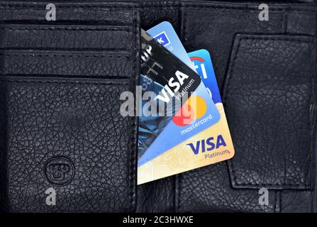 Debit and Credit cards in black color wallet. Top view. Stock Photo