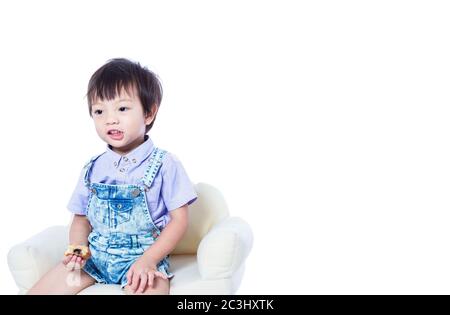 Children sitting on the chair and holding food. Stock Photo