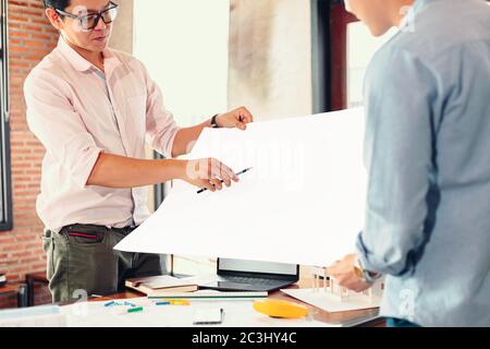 industry manager and engineer, businessman reading and checking blueprint, drawing  in the room Stock Photo