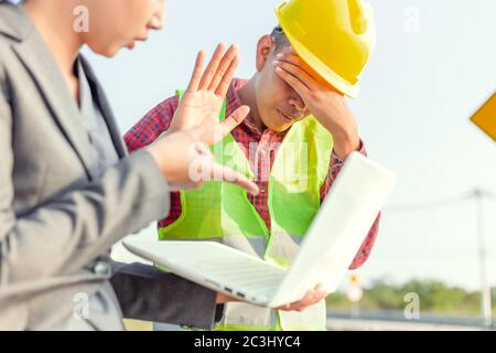 A man  raise hands up for stop and give up. Foreman afraid manager at site construction. Stock Photo