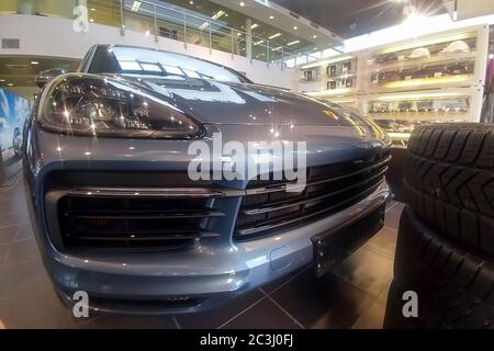 Moscow, Russia - June 01, 2019: Front grille, hood and headlights of a Porsche Cayenne SUV 2019. The car is in the showroom. Stock Photo