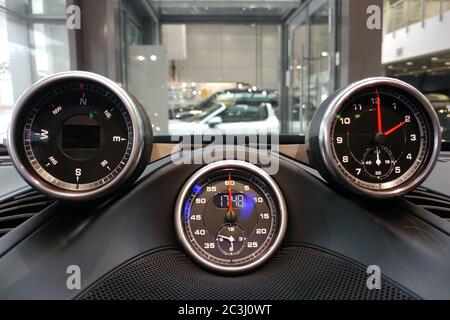 Moscow, Russia - April 23, 2019: Interior details of a sports car Porsche. Sports chronometer with electronic clock, compass or analog clock to choose from. Options for installation on the dashboard. Stock Photo