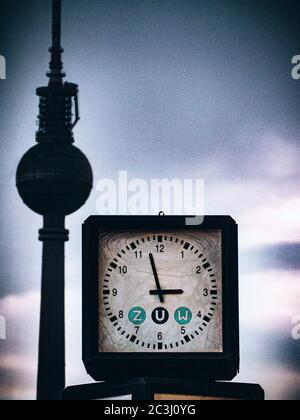 Closeup low angle shot of a street clock on the Berliner Fernsehturm background Stock Photo