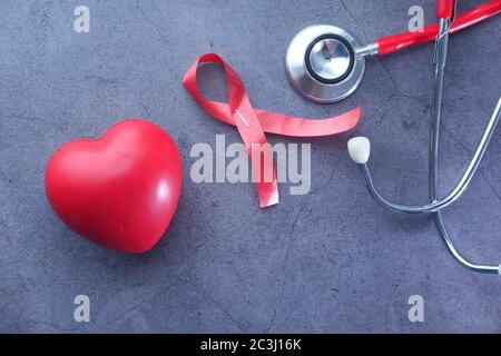 Black ribbon and stethoscope on white background. Melanoma concept ...