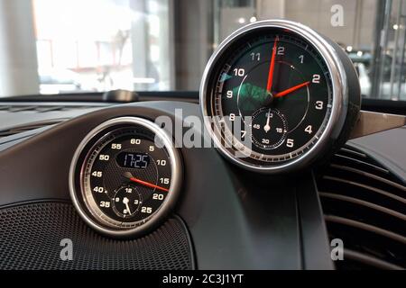 Moscow, Russia - April 23, 2019: Interior details of a sports car Porsche. Sports chronometer with electronic clock or analog classic clock to choose from. Options for installation on the dashboard. Stock Photo