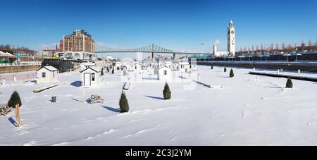 A panorama of the frozen St Lawrence river  and Jacques Cartier Bridge in downtown Montreal. In winter, temporary fishing huts are erected on the ice. Stock Photo