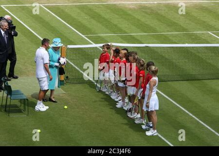 Queen Elizabeth II greets children on Court # 14 during her first visit to Wimbledon in 33 years. Stock Photo