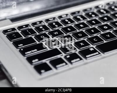 gray colored laptop focused on black keyboard Stock Photo