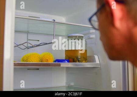 Portrait of a hungry man looking for food in refrigerator. Man looking inside an empty refrigerator Stock Photo