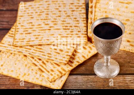 Matzah and a silver cup full of wine. Jewish holidays Passover concept. Stock Photo