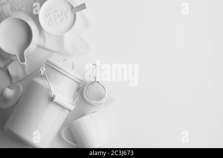 Monochrome composition of white figures of dairy products, milk in a jug on a white background. Banner with copy space for text. A set of food on the Stock Photo