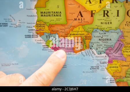 'RAK, RAK/UAE - 4/12/2020: Finger pointing to a colorful country map in English and French Ivory Coast (Cote D'Ivoire). ' Stock Photo