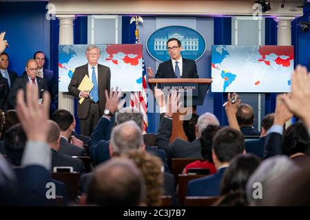 Washington, United States Of America. 28th Jan, 2019. Secretary of the Treasury Steven Mnuchin, joined by National Security Advisor John Bolton and Director of the National Economic Council Larry Kudlow, addresses reporters in the James S. Brady Press Briefing Room at the White House Monday, Jan. 28, 2019, to announce additional steps to address the national emergency with respect to Venezuela. People: Secretary of the Treasury Steven Mnuchin, Credit: Storms Media Group/Alamy Live News Stock Photo