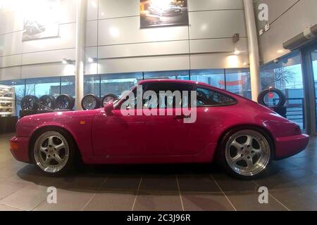 Moscow. February 2019. Side view of Porsche 930. Classic collectible Pink Porsche 911 carrera RS in showroow of dealer center. Stock Photo
