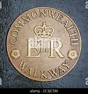 Commemorative Commonwealth Walkway brass plaque. Street sign set in the pavement, Glasgow, Scotland, UK