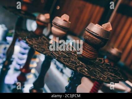 Hot close up red coals with hookah sparks in ceramic bowl for Shisha Smoking Coal for hookah and relaxation. Stock Photo